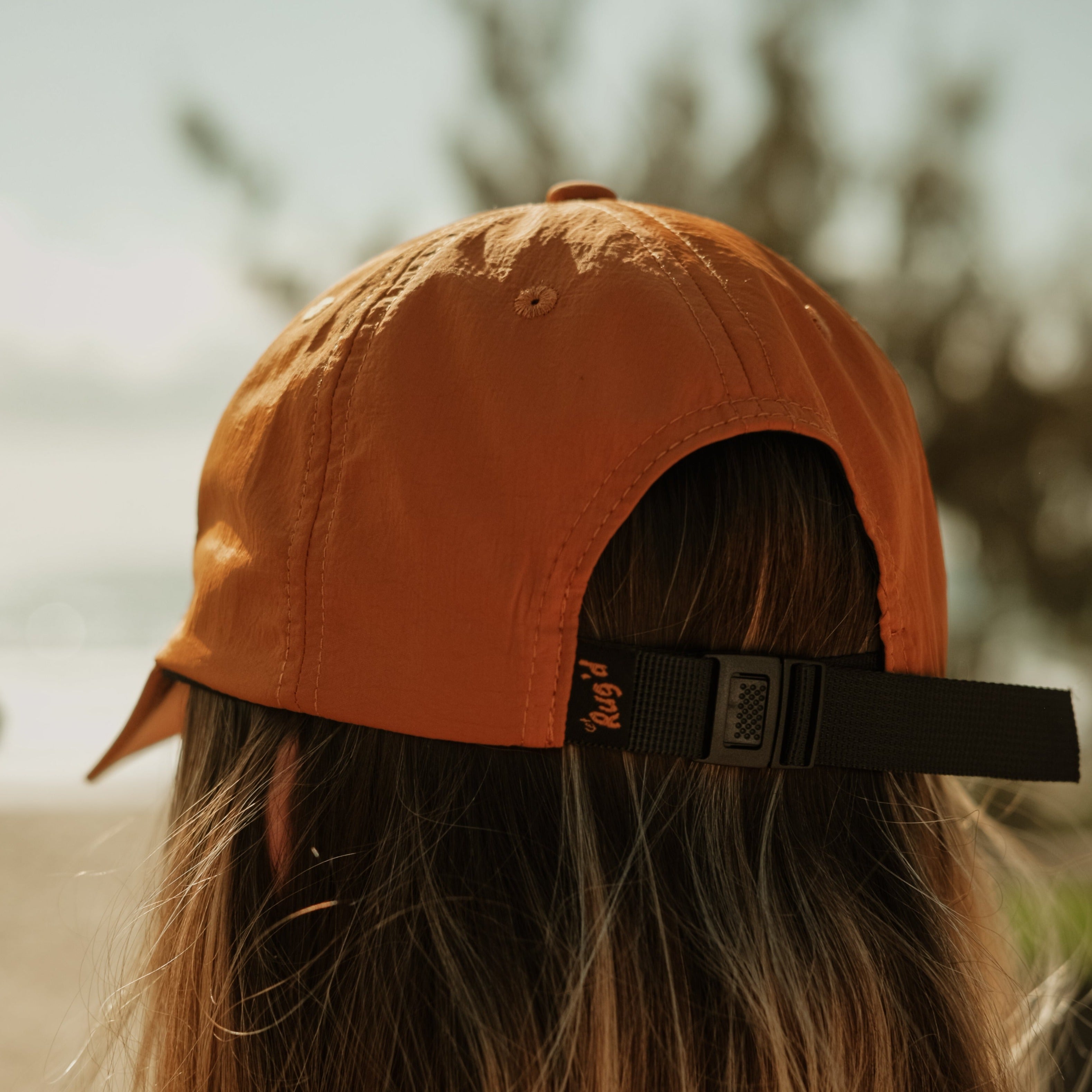 Brown outdoor cap with adjustable strap, perfect for casual outdoor adventures