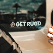 Get Rug'd car decal sticker coaster pack displayed on a car window