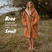 Get Rug'd Hydrocloak waterproof cream robe in orange with a cozy design and fur-lined hood