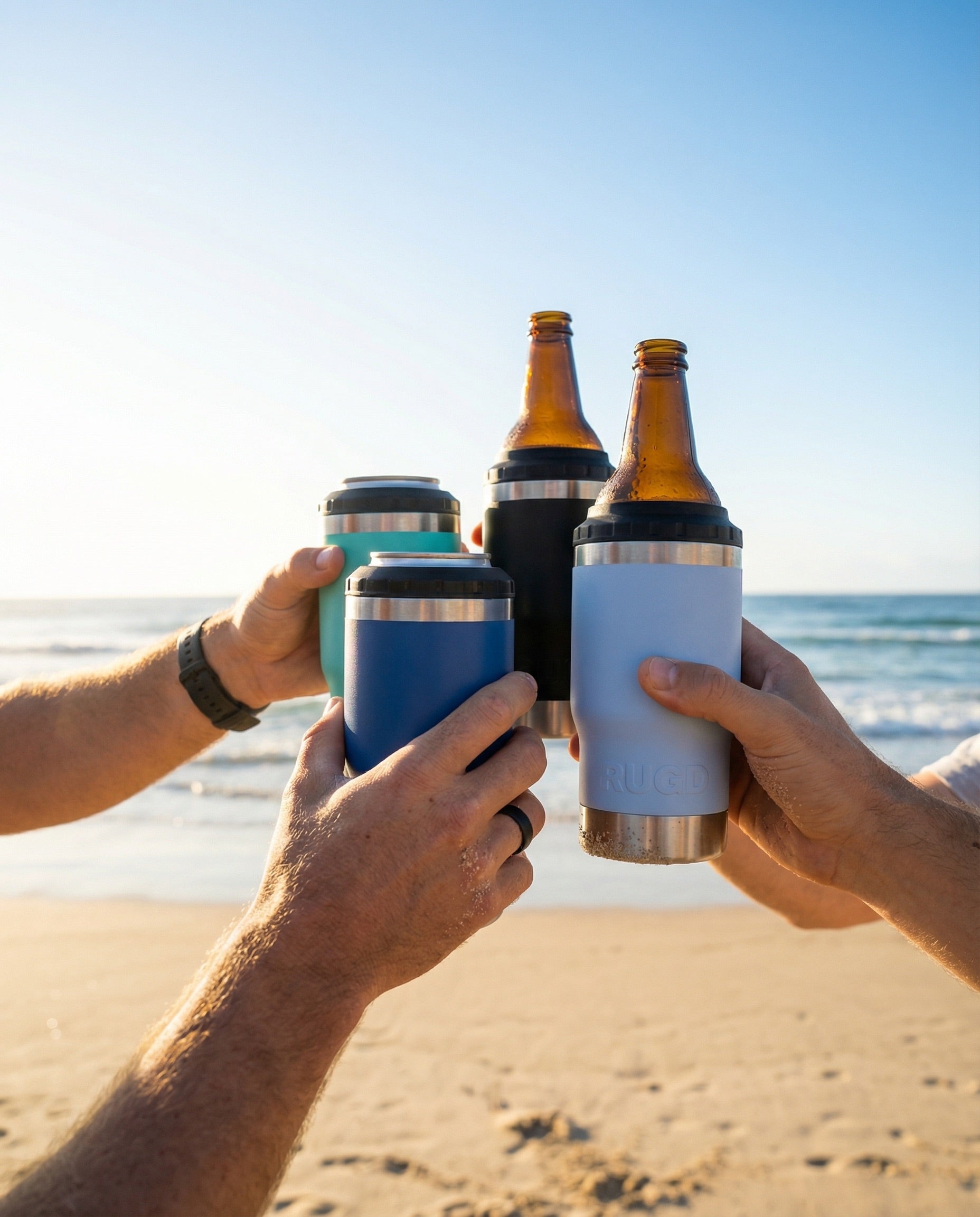 The Original Stubby Cooler and Coffee Cup from RUGD. 4 Perople Cheersing on the beach. Australian designed.