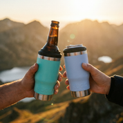 Two hands holding blue and white insulated cups with a sunset and mountains in the background