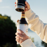 Best Stubby Cooler Coffee Cup being used to hold a drink outdoors by a person