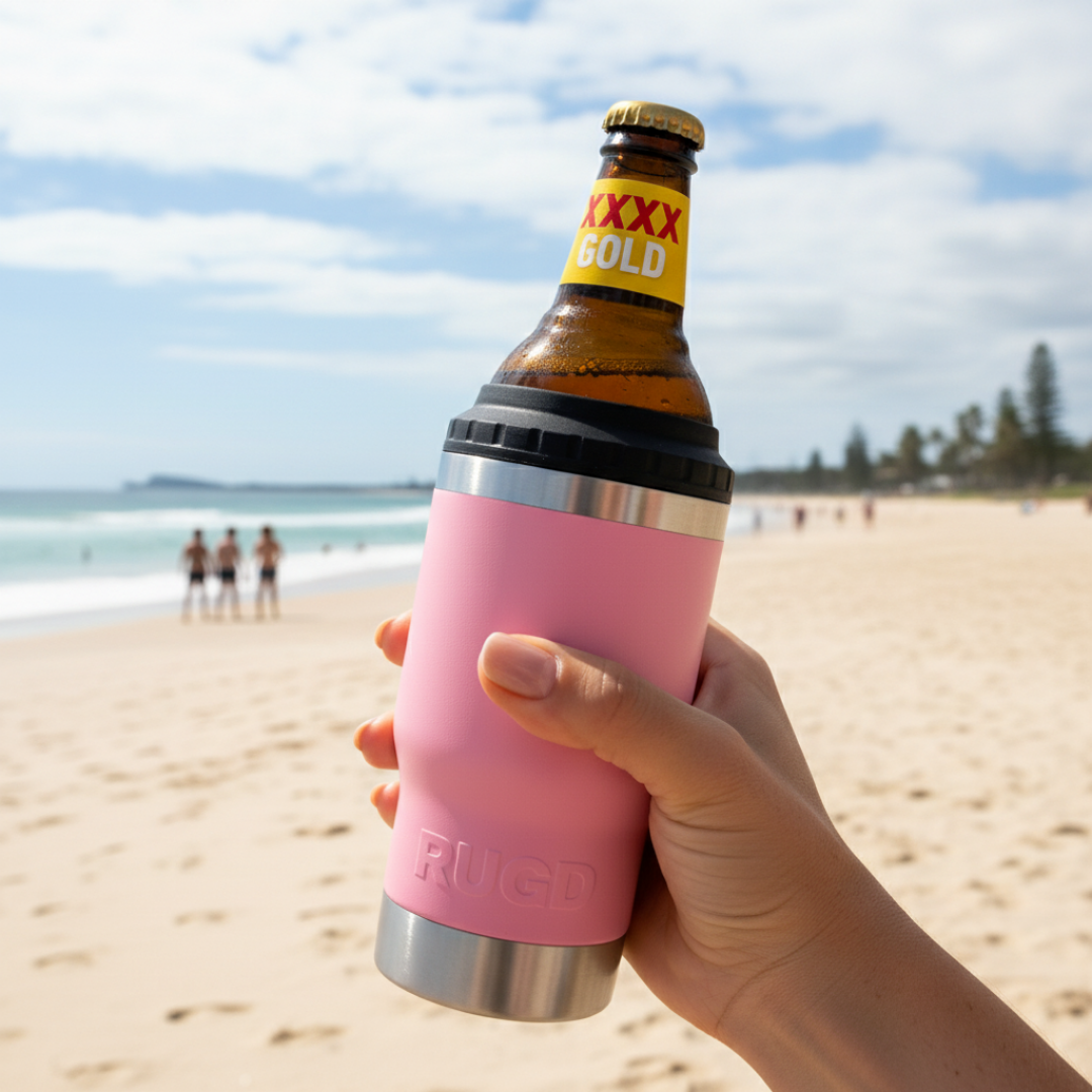 Get Rug'd StubCup Pink can cooler drinking cup holding a beer bottle on the beach