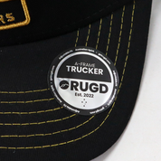 Get Rug'd A-Frame Trucker Cap in Black with Yellow Stitched Logo and Established 2022 Tag
