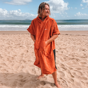 Get Rug'd Towel Poncho in Rust Color, Perfect for Beach Days and Surfing with a Cozy Hood and Front Pocket